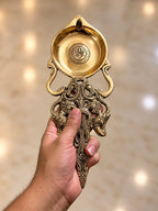 brass pooja spoon in hand2