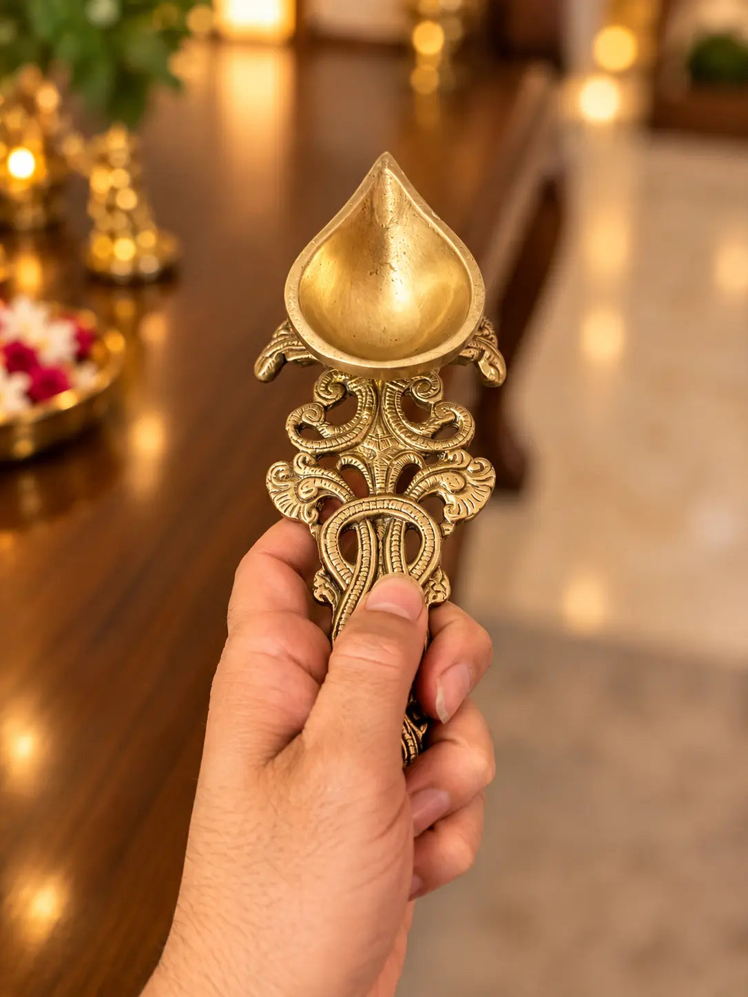 brass Aarti diya spoon on hand