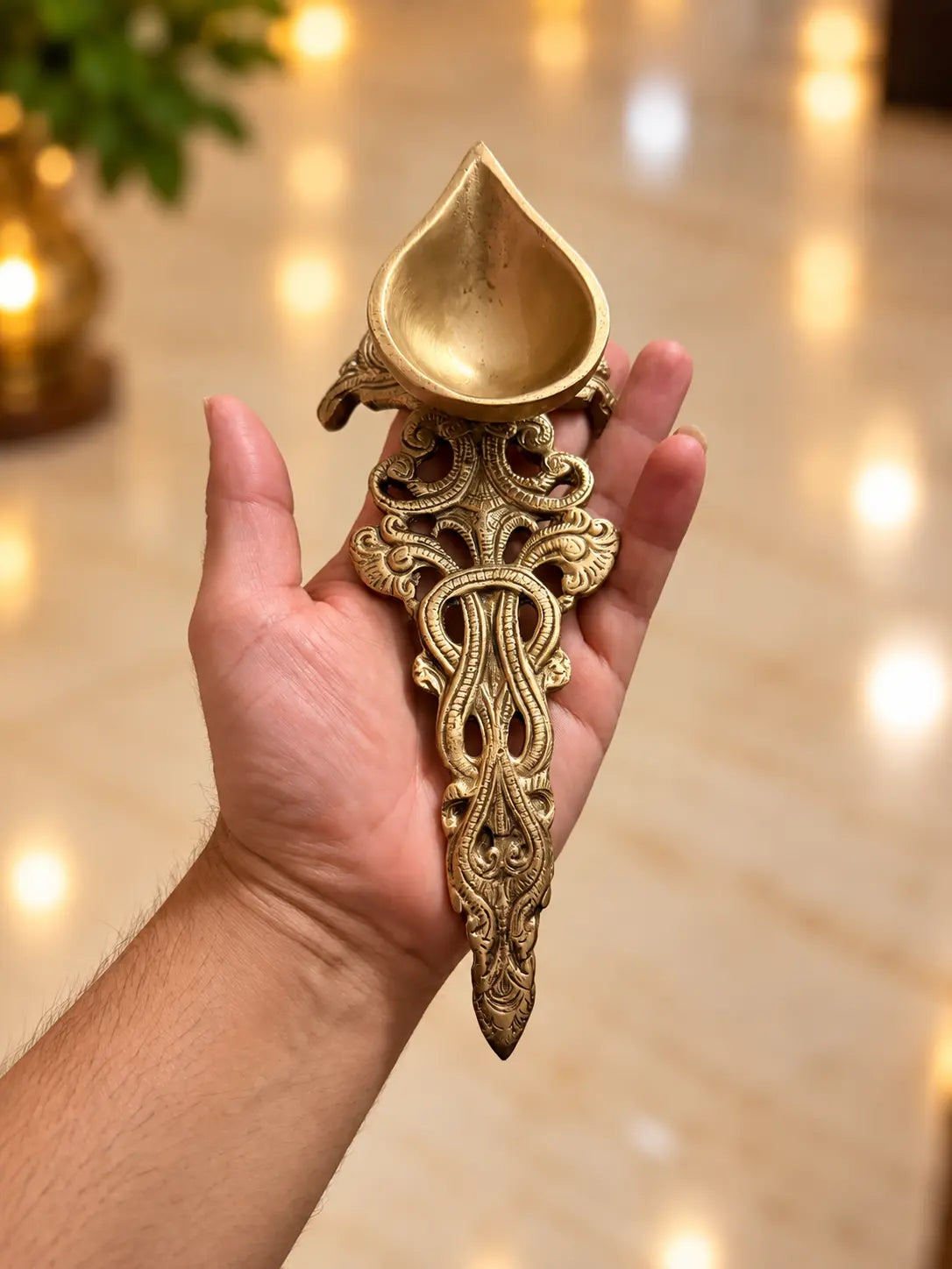 brass Aarti diya spoon on hand