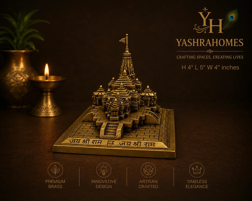 A brass miniature temple model of Jay Shri Ram's temple on a square base, displayed on a dark brown background with decorative brass lamps and a plant. The image includes branding for Yashrahomes and feature icons at the bottom.
