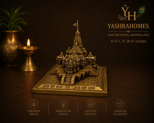 A brass miniature temple model of Jay Shri Ram's temple on a square base, displayed on a dark brown background with decorative brass lamps and a plant. The image includes branding for Yashrahomes and feature icons at the bottom.